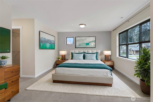 bedroom featuring baseboards and multiple windows