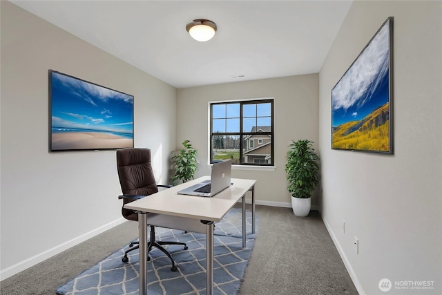 carpeted office space with visible vents and baseboards