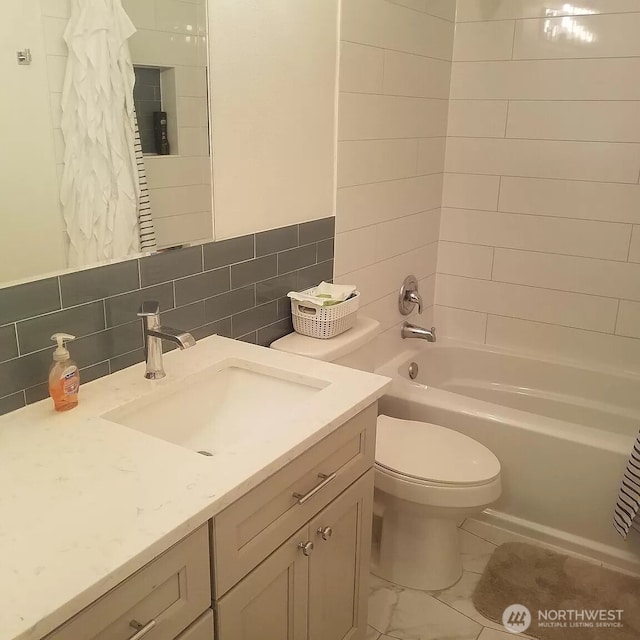 bathroom featuring toilet, shower / bathtub combination with curtain, tile walls, and vanity