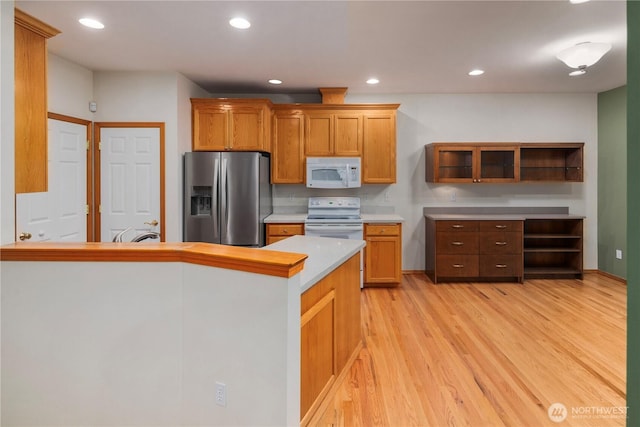 kitchen with white appliances, light countertops, light wood-type flooring, open shelves, and recessed lighting