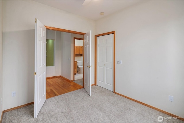 unfurnished bedroom with light carpet, ceiling fan, and baseboards