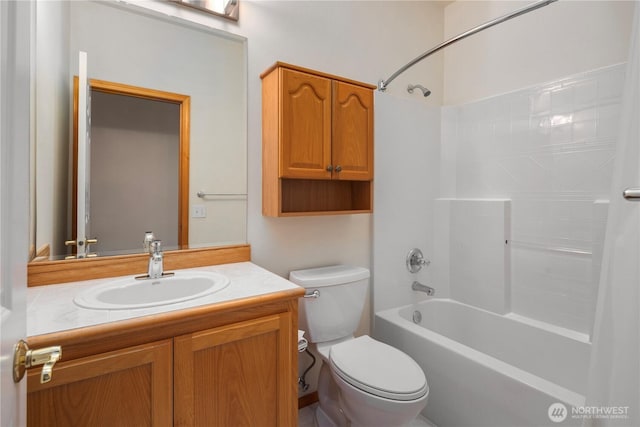 bathroom featuring toilet, washtub / shower combination, and vanity