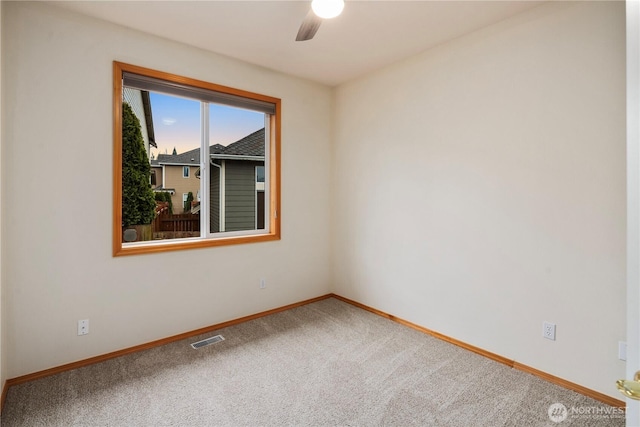 empty room featuring baseboards, visible vents, ceiling fan, and carpet flooring