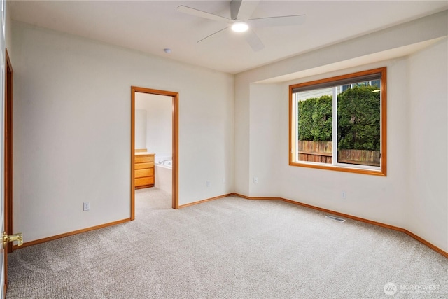 empty room with a ceiling fan, visible vents, light carpet, and baseboards