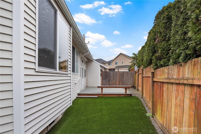 view of yard with a fenced backyard and a wooden deck