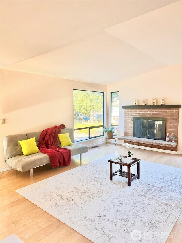 living room with wood finished floors and a fireplace