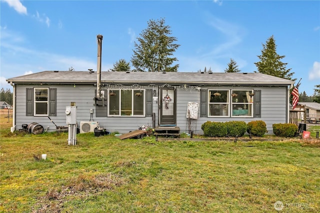 ranch-style home with ac unit and a front lawn