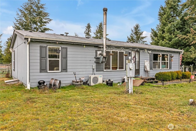 view of front of property featuring a front lawn and ac unit