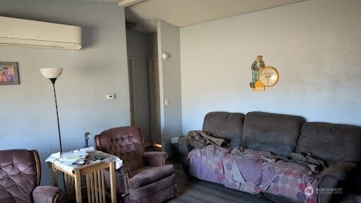 living room featuring a wall unit AC