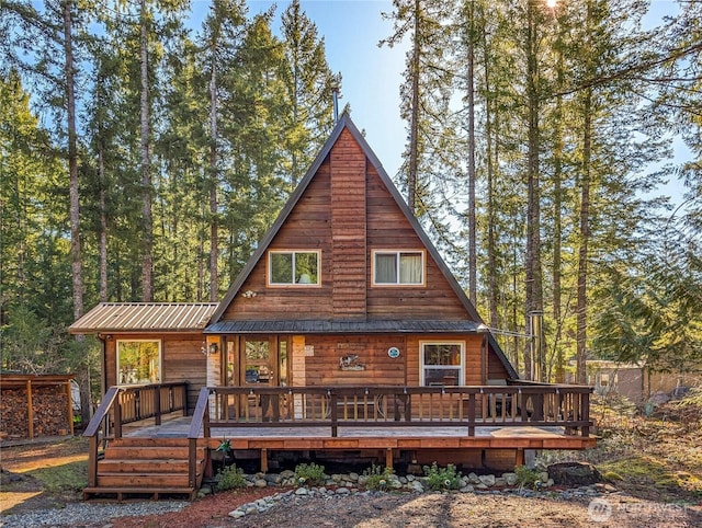 view of front of house featuring metal roof and a deck