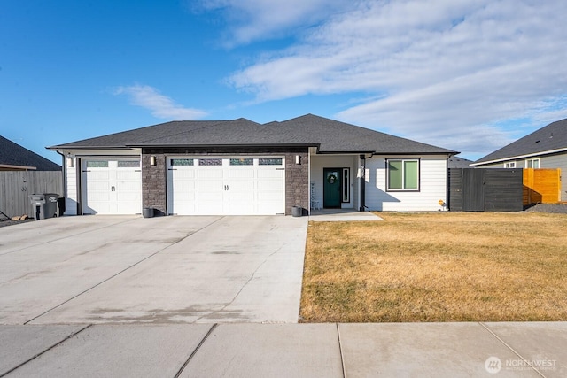 view of front facade featuring a garage, concrete driveway, a front yard, and fence