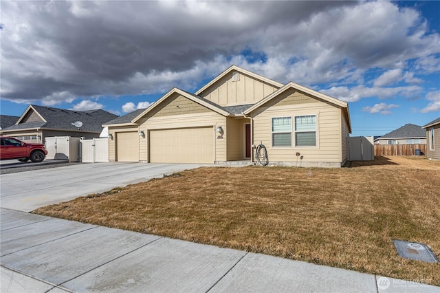 view of front of house with concrete driveway, an attached garage, fence, and board and batten siding