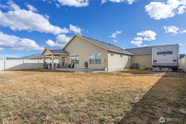 rear view of property featuring central AC unit, a patio, a yard, and fence