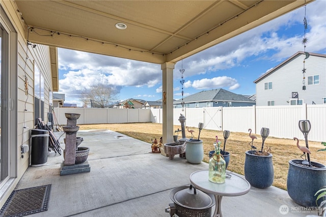 view of patio featuring a residential view and a fenced backyard