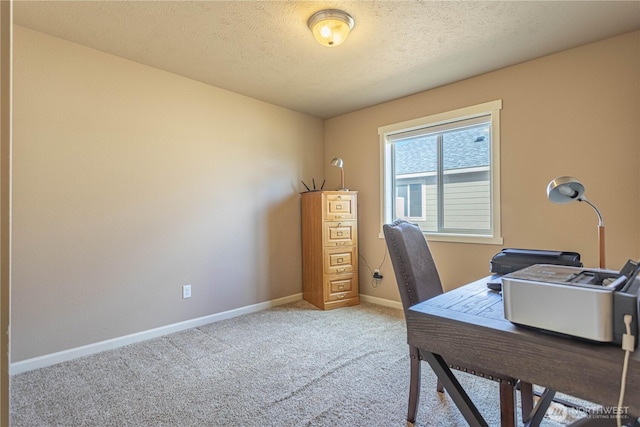 home office featuring baseboards, light colored carpet, and a textured ceiling