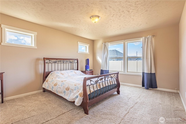 carpeted bedroom with baseboards and a textured ceiling