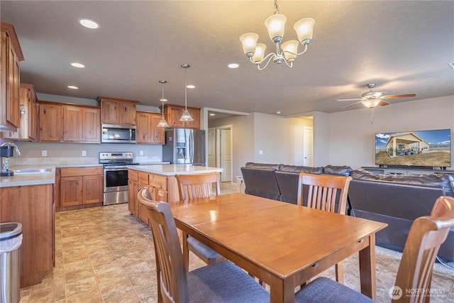 dining room featuring recessed lighting and ceiling fan with notable chandelier