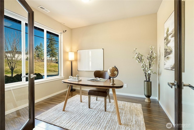 office space featuring baseboards, visible vents, dark wood-type flooring, and french doors