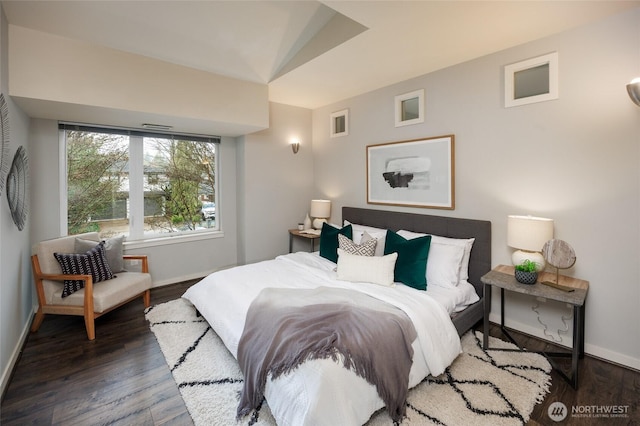 bedroom featuring baseboards and wood finished floors