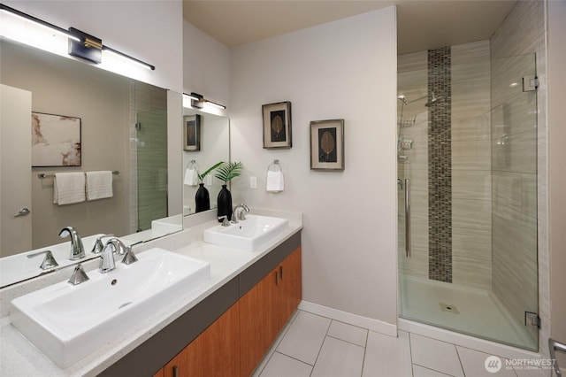 full bathroom featuring a stall shower, tile patterned flooring, and a sink