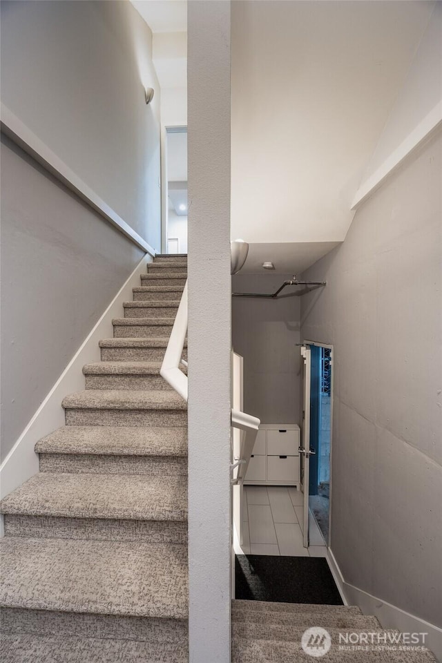 stairs featuring tile patterned floors