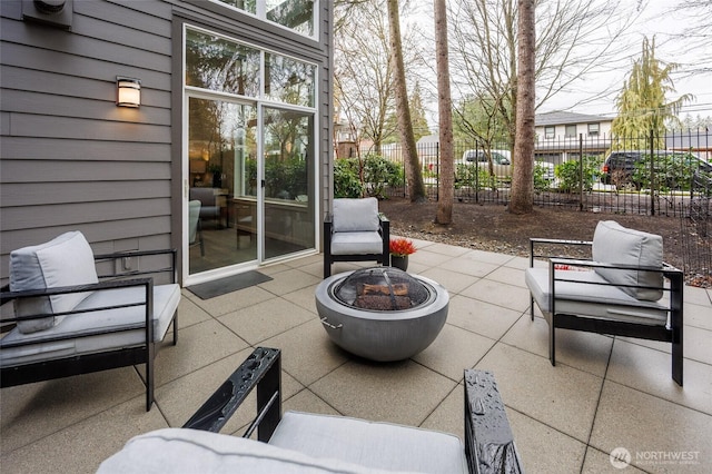 view of patio with fence and a fire pit