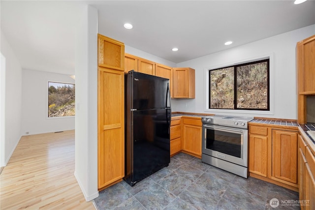 133 Long Dr, Chelan, WA 98816 - kitchen with tile countertops, freestanding refrigerator, recessed lighting, wood finished floors, and electric stove