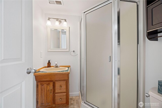 133 Long Dr, Chelan, WA 98816 - bathroom featuring visible vents, toilet, a shower stall, and vanity