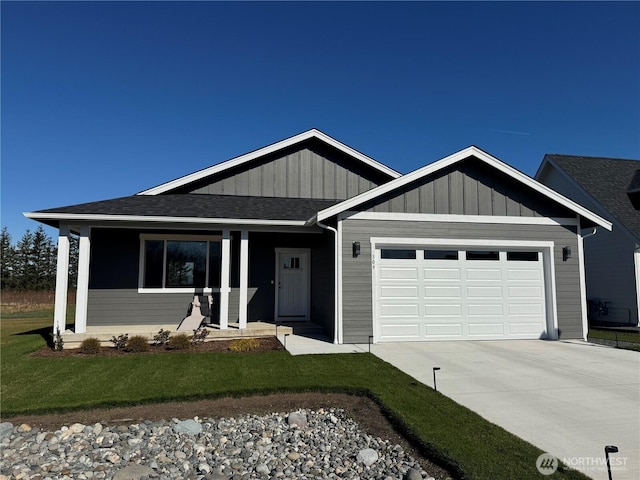 ranch-style house with roof with shingles, an attached garage, board and batten siding, driveway, and a front lawn