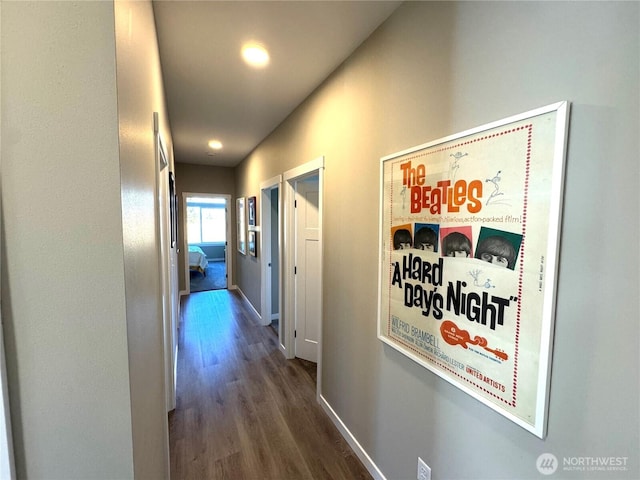 hallway with wood finished floors and baseboards