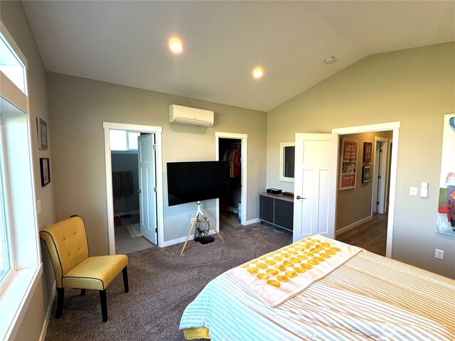 bedroom featuring vaulted ceiling, a spacious closet, a wall mounted AC, a closet, and dark colored carpet