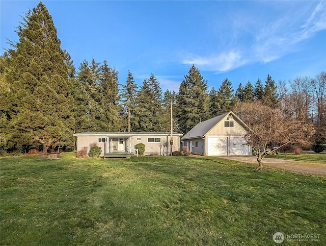 view of front of home featuring a garage, driveway, and a front lawn