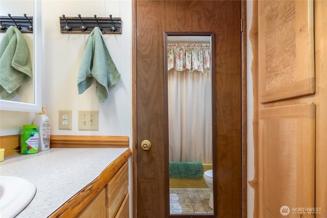 bathroom featuring vanity and toilet