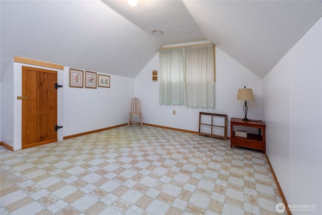 bonus room featuring vaulted ceiling and baseboards