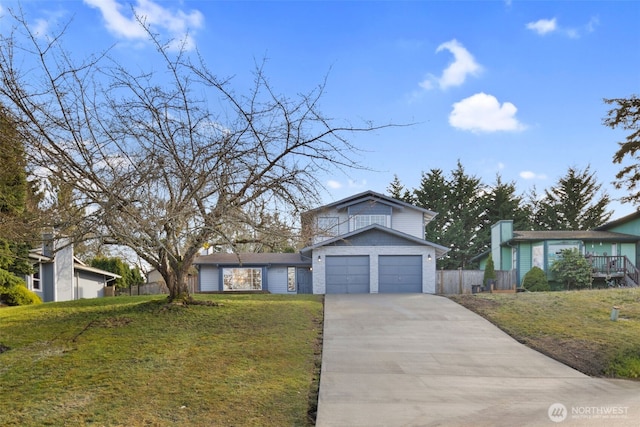 view of front of property with an attached garage, fence, a front lawn, and concrete driveway