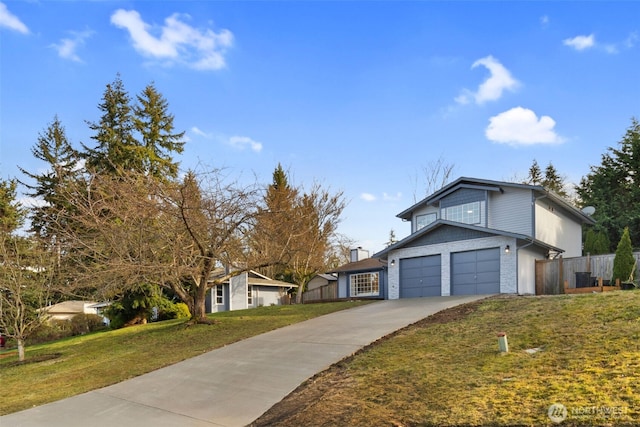 view of front of home with stone siding, fence, concrete driveway, and a front yard