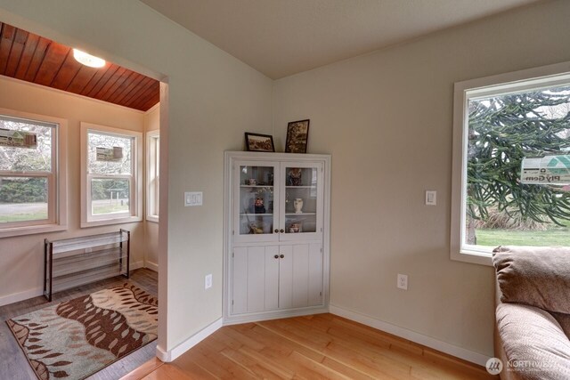 living area featuring light wood-type flooring and baseboards