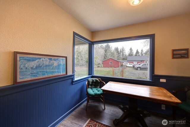 home office featuring wainscoting and wood finished floors