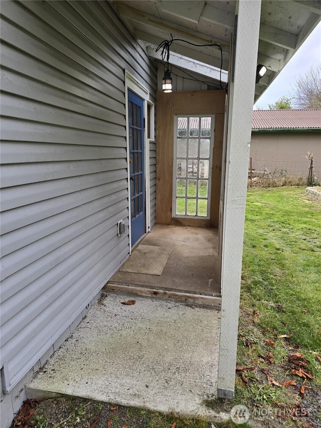 property entrance with a yard