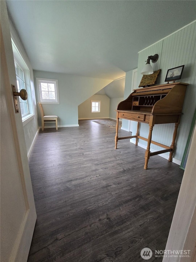 office space with lofted ceiling, dark wood-style flooring, and baseboards