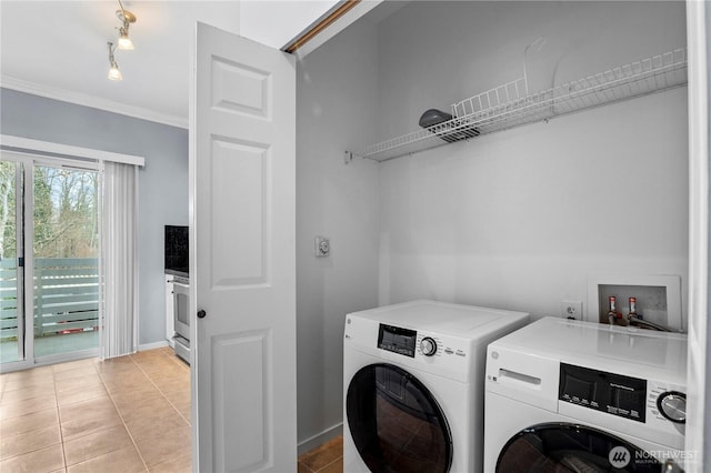 laundry area featuring laundry area, light tile patterned floors, baseboards, independent washer and dryer, and crown molding