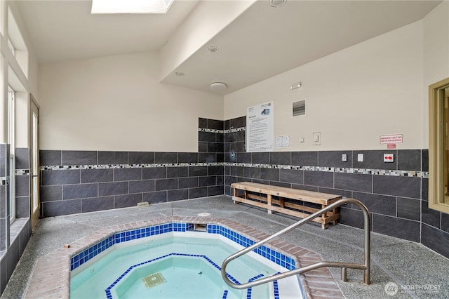 view of pool with an indoor hot tub