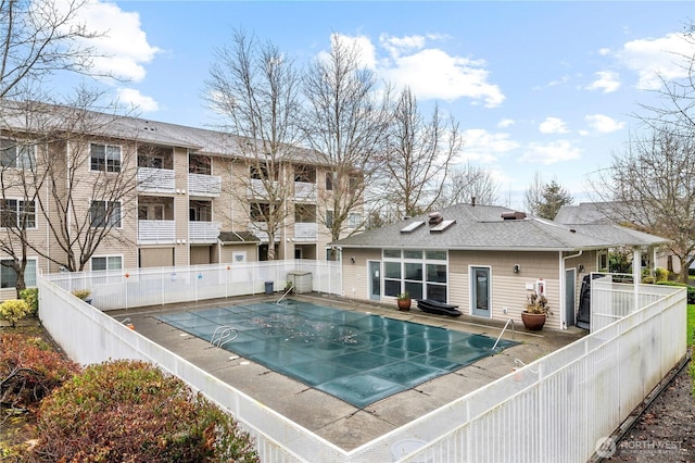 view of swimming pool featuring a patio area, fence, and a fenced in pool