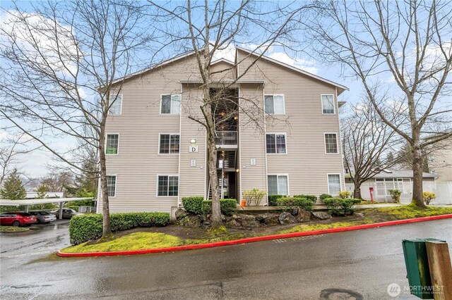 view of property featuring covered parking