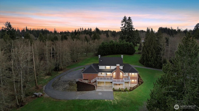 aerial view at dusk with a wooded view