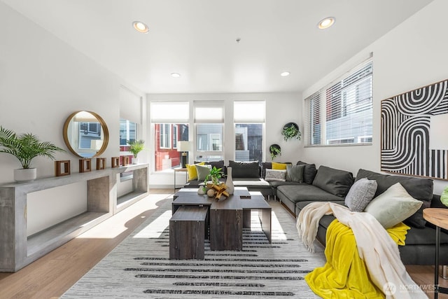 living area featuring recessed lighting, wood finished floors, and a healthy amount of sunlight