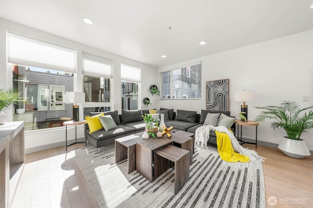 living room featuring light wood-style floors, recessed lighting, and baseboards