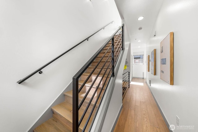 staircase with wood-type flooring, baseboards, and recessed lighting