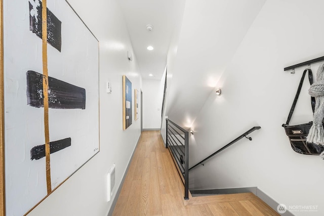 corridor featuring visible vents, recessed lighting, light wood-style flooring, and baseboards