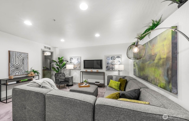 living room with baseboards, visible vents, and recessed lighting